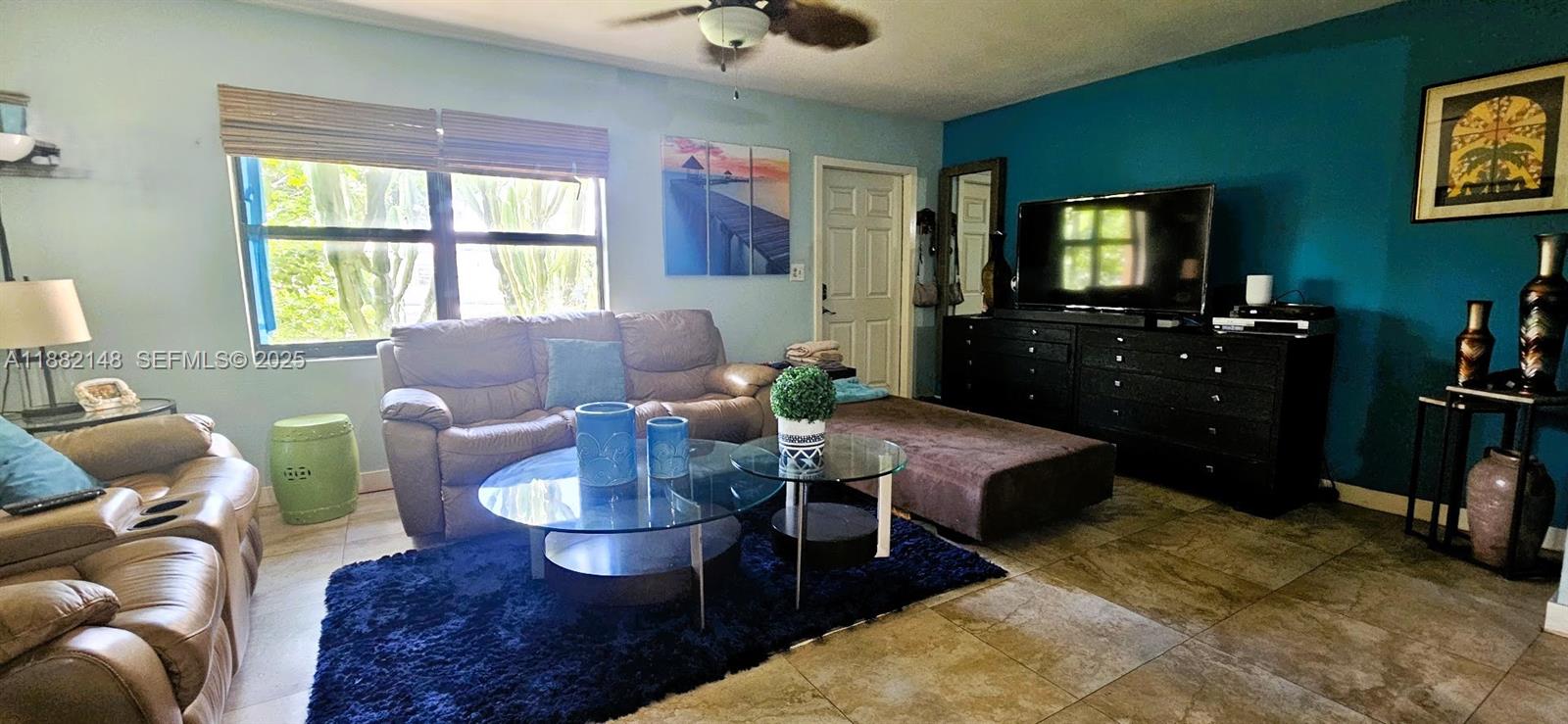 243 Northwest 62nd Court Miami, FL 33126 - Photo 8 of 19 a living room with furniture and a flat screen tv