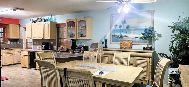 a kitchen with a table chairs stove and cabinets