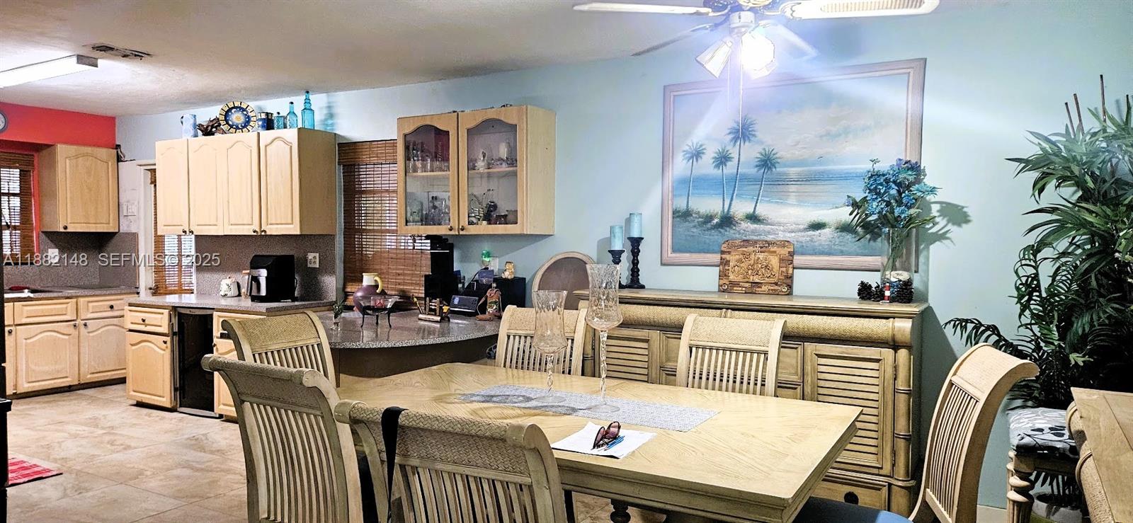 243 Northwest 62nd Court Miami, FL 33126 - Photo 9 of 19 a kitchen with a table chairs stove and cabinets