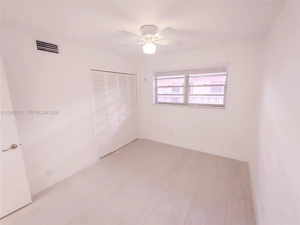 a kitchen with white cabinets stainless steel appliances and sink
