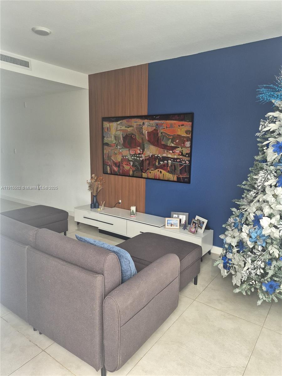 14515 Southwest 261st Street, Unit 14515 Homestead, FL 33032 - Photo 12 of 13 a living room with a couch