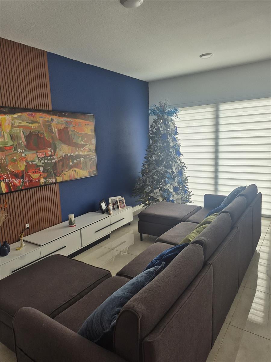14515 Southwest 261st Street, Unit 14515 Homestead, FL 33032 - Photo 10 of 13 a living room with furniture and a window