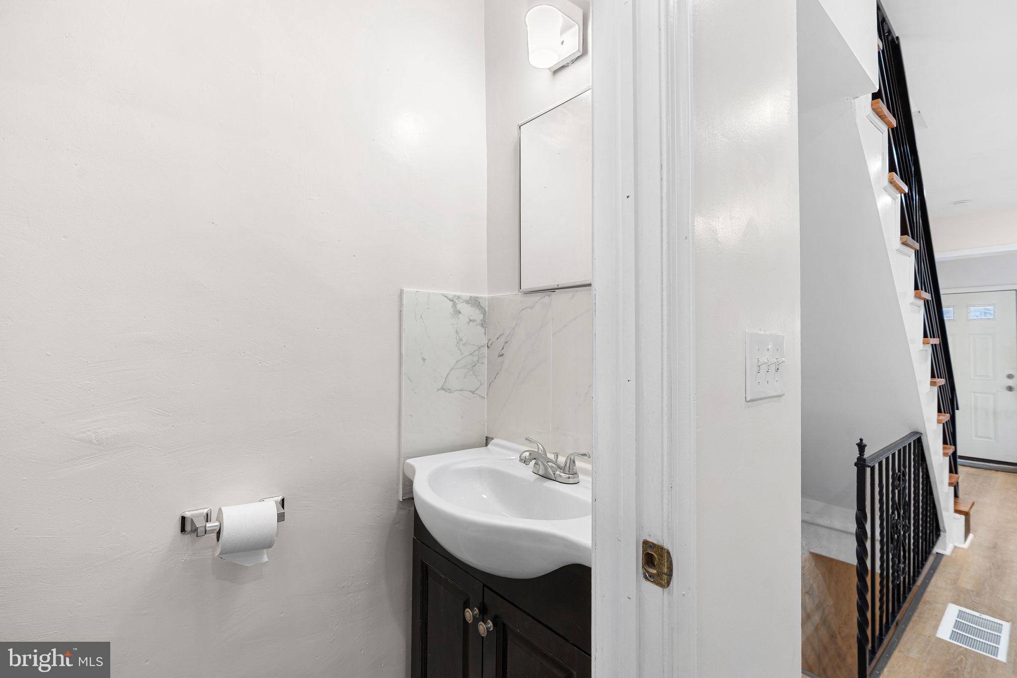 5428 Regent Street Philadelphia, PA 19143 - Photo 12 of 28 a bathroom with a sink and a mirror