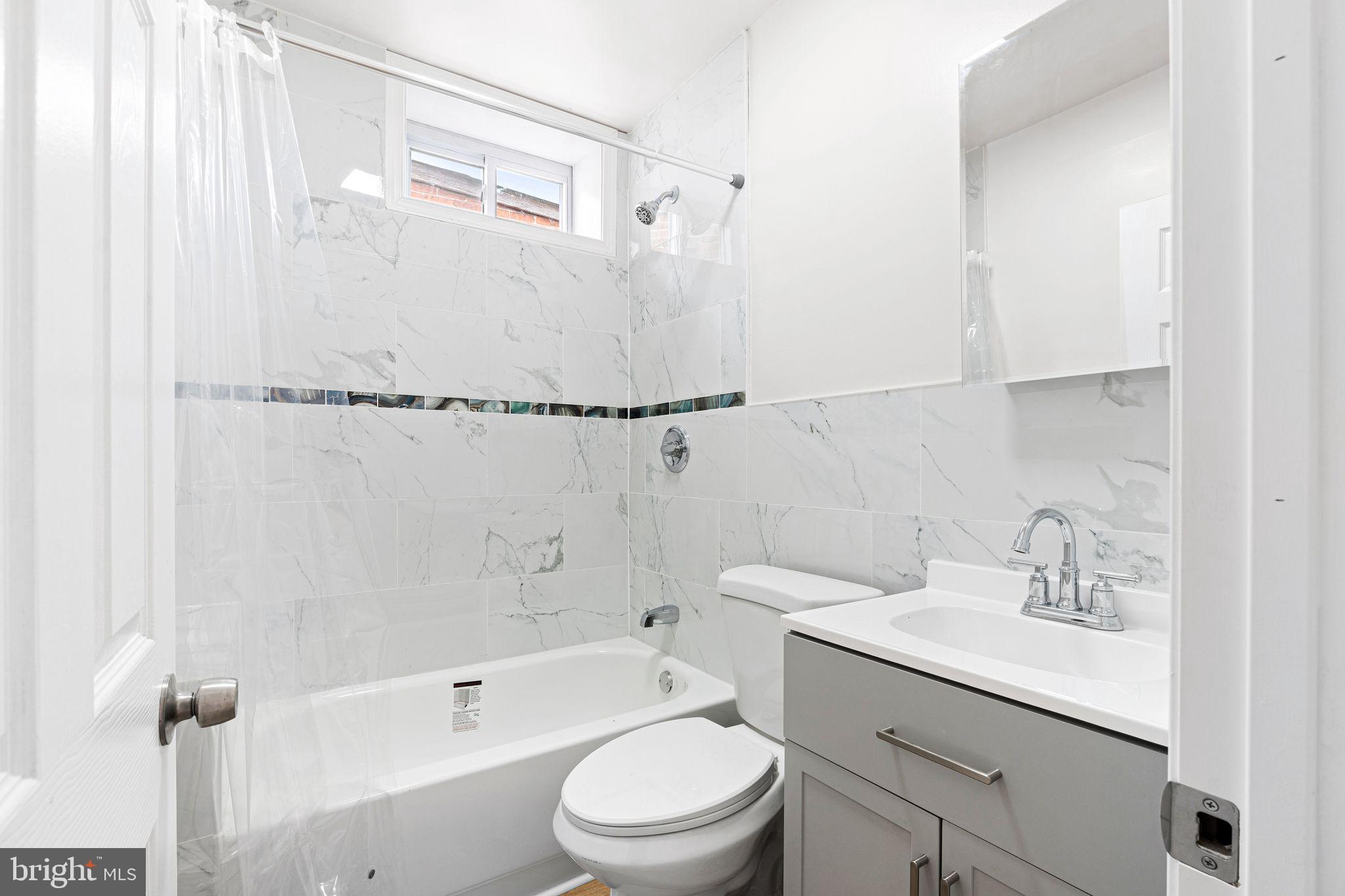 5428 Regent Street Philadelphia, PA 19143 - Photo 18 of 28 a bathroom with a sink a toilet and shower