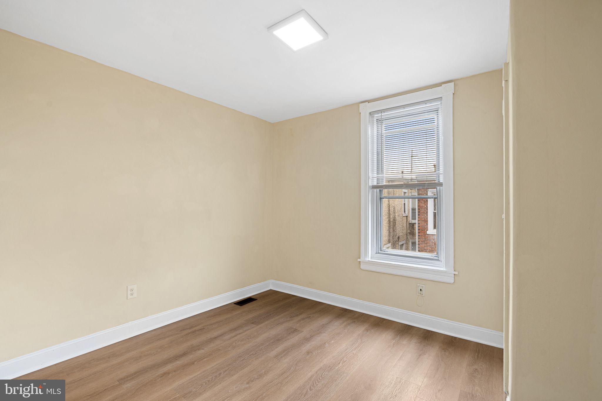 5428 Regent Street Philadelphia, PA 19143 - Photo 23 of 28 an empty room with wooden floor and windows