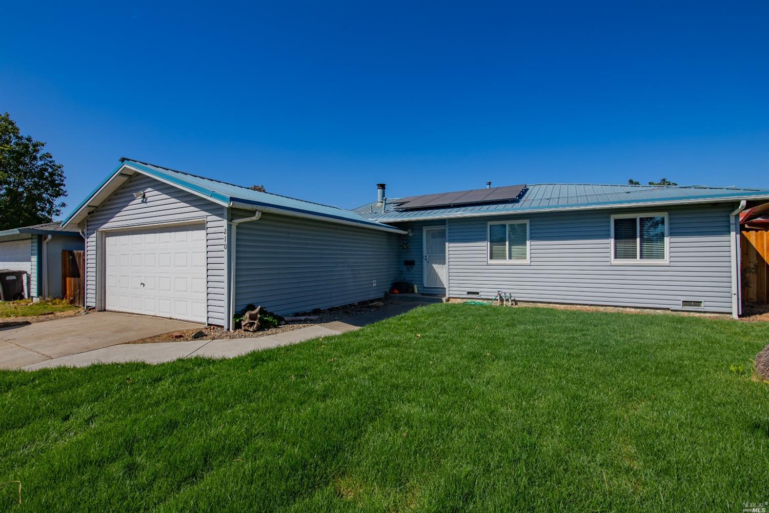 210 Yosemite Drive Rio Vista, CA 94571 - Photo 1 of 1 a front view of a house with a yard and garage