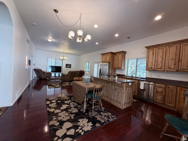 2855 South 1000 West Perry, UT 84302 - Photo 110 of 142 Kitchen featuring a center island with sink, stainless steel appliances, suspended lighting, and dark wood finished floors