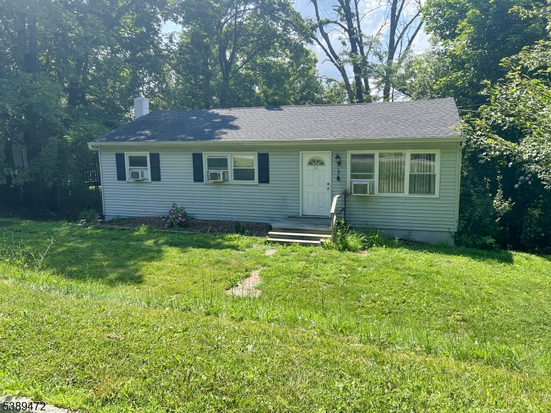 a view of a yard in front of a house with large trees