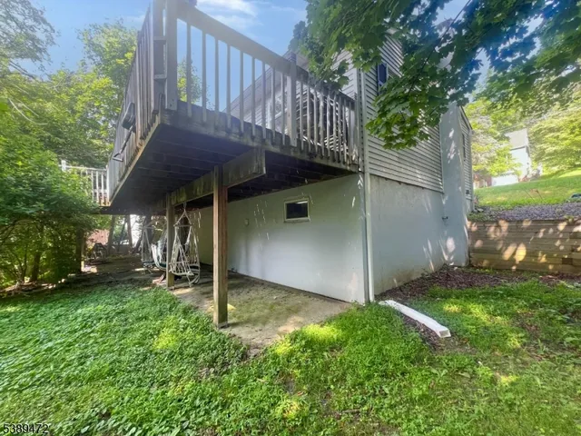 a view of a house with a yard and deck