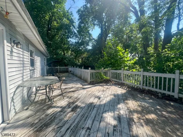 a view of backyard with a table and chairs and wooden floor