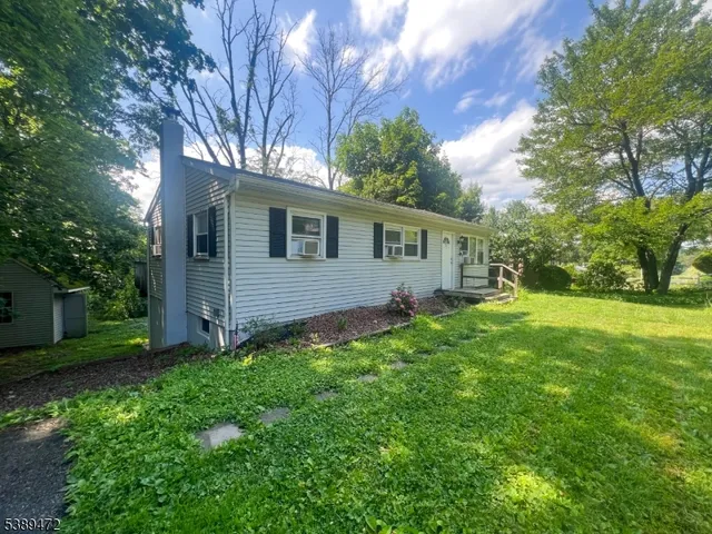 a view of backyard of house with green space