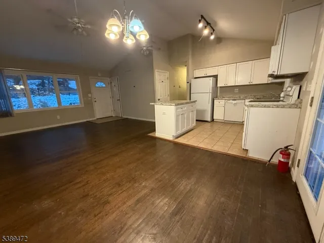 a view of a kitchen with stove and cabinets
