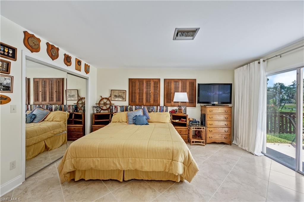 397 Forest Hills Boulevard Naples, FL 34113 - Photo 14 of 29 Master Bedroom with sliding glass doors out to the backyard area.