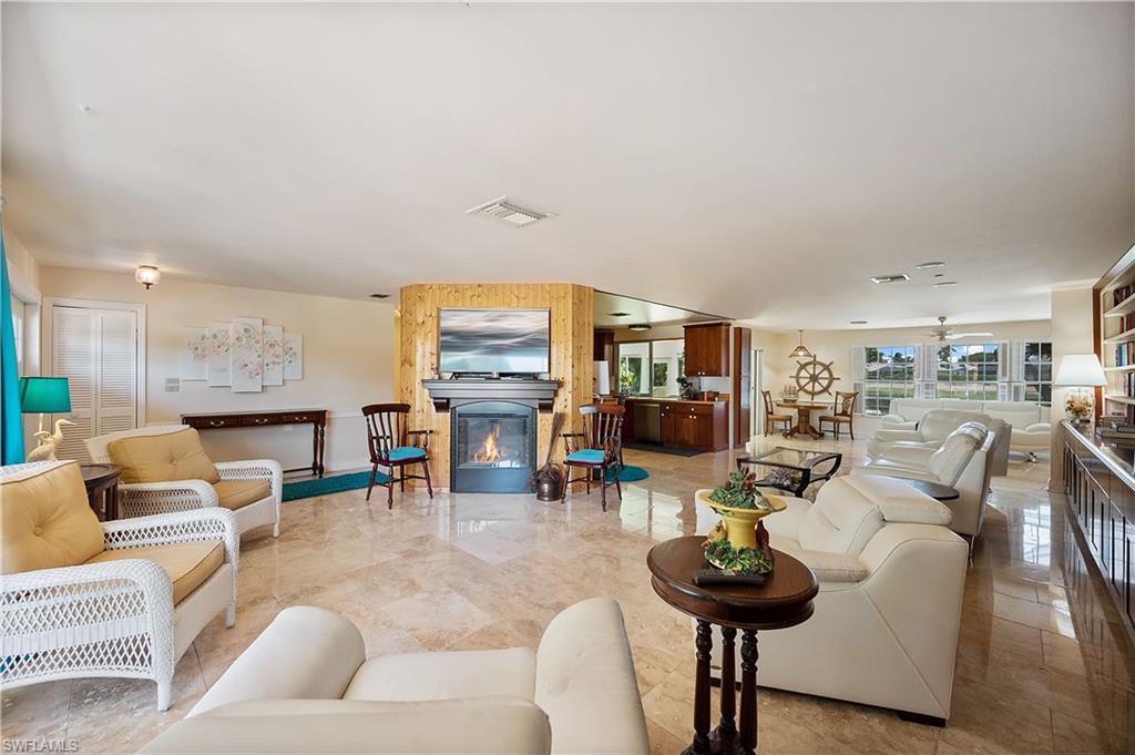 397 Forest Hills Boulevard Naples, FL 34113 - Photo 5 of 29 Living Room with electric fireplace that is an additional source of heat and relaxation for added comfort.
