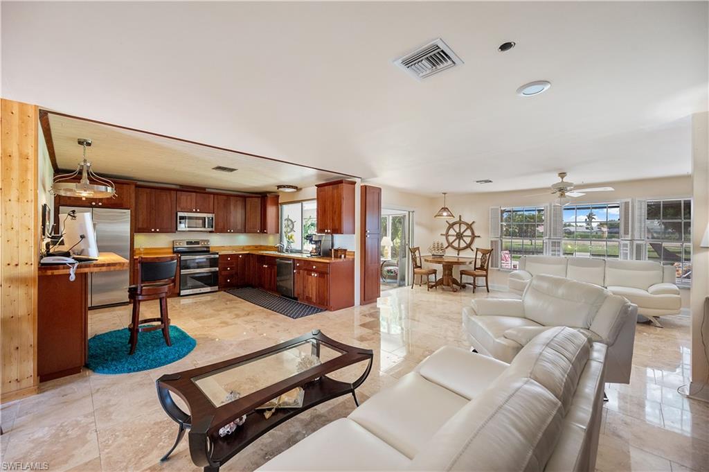 397 Forest Hills Boulevard Naples, FL 34113 - Photo 6 of 29 Living room leading into the Kitchen and Sitting area.