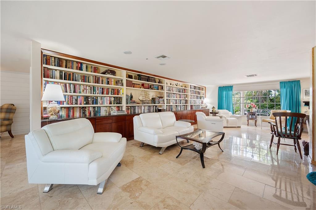 397 Forest Hills Boulevard Naples, FL 34113 - Photo 7 of 29 Living room with custom built in bookshelf.