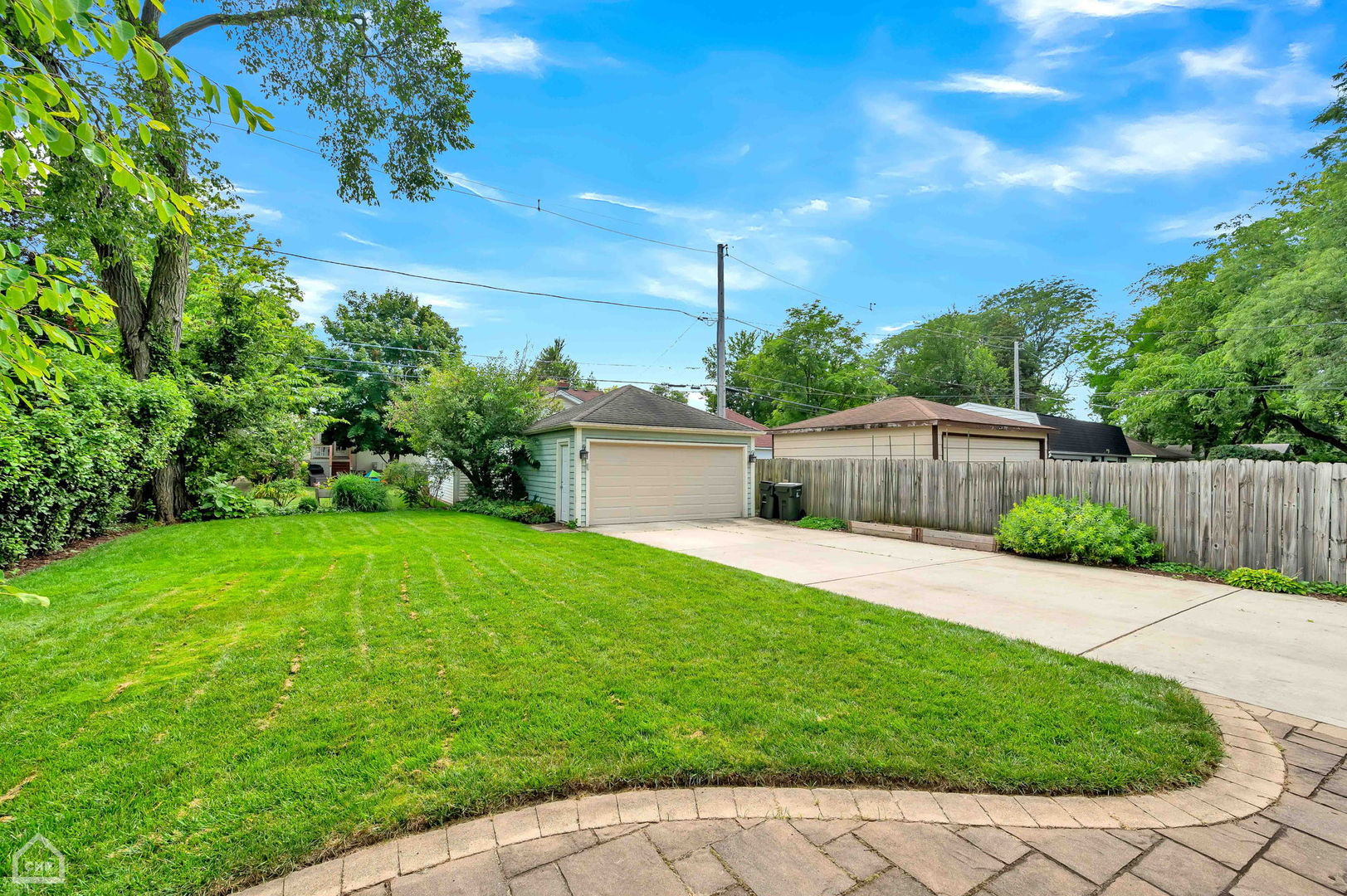 267 Lawton Road Riverside, IL 60546 - Photo 38 of 44 a view of a backyard with potted plants and wooden fence