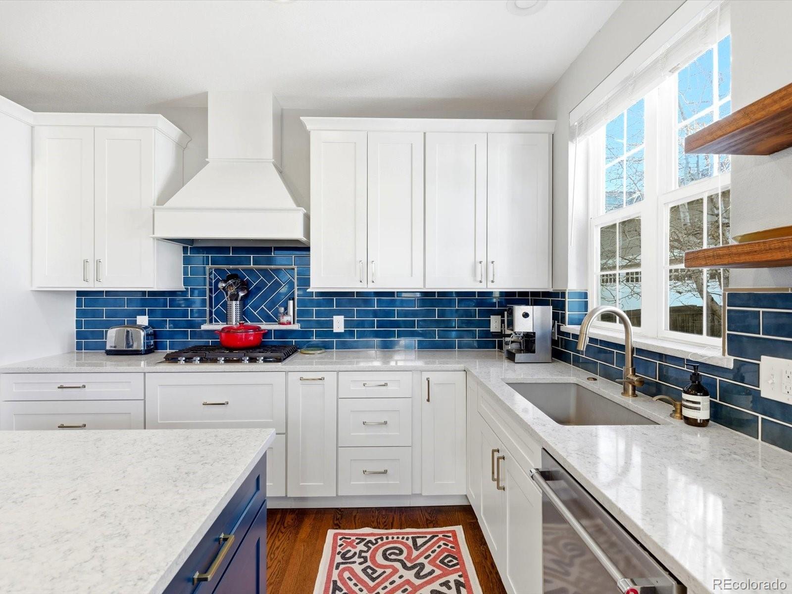 2691 Spruce Street Denver, CO 80238 - Photo 16 of 36 a kitchen with granite countertop a sink a stove and cabinets