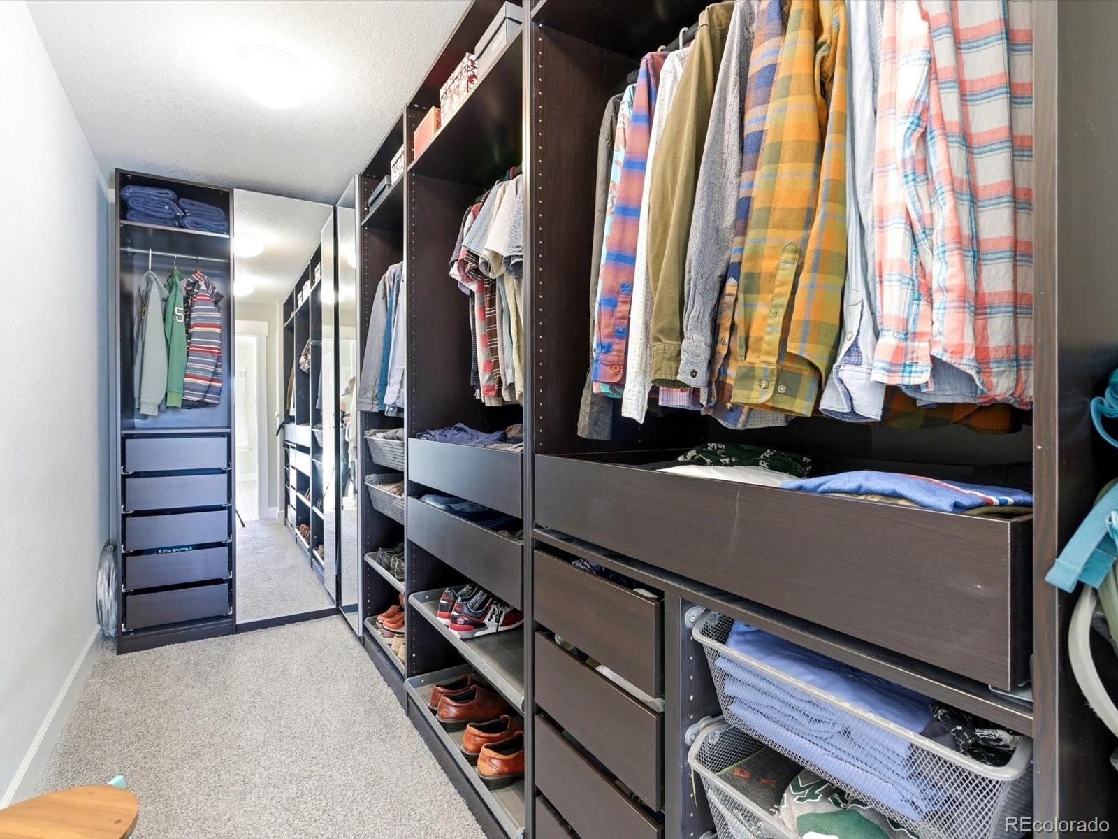 2691 Spruce Street Denver, CO 80238 - Photo 24 of 36 a view of walk in closet with clothes and shoes