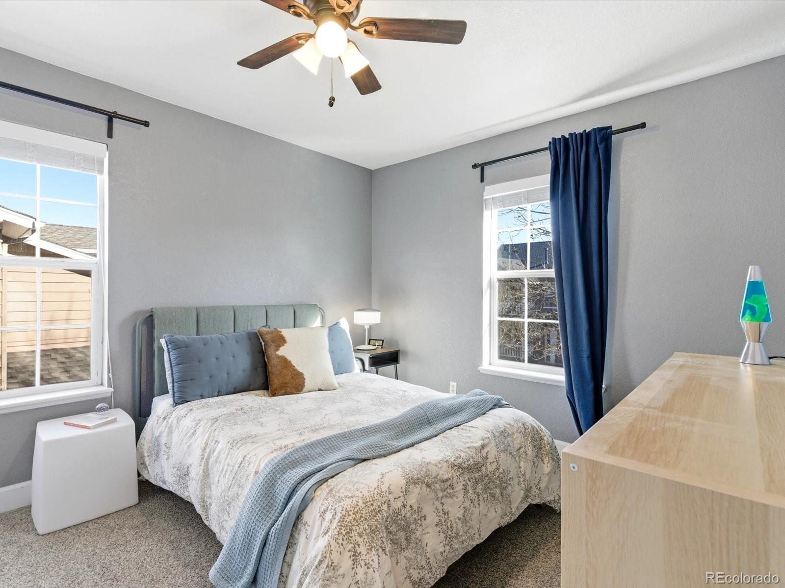 2691 Spruce Street Denver, CO 80238 - Photo 28 of 36 a bedroom with a large bed and a chandelier