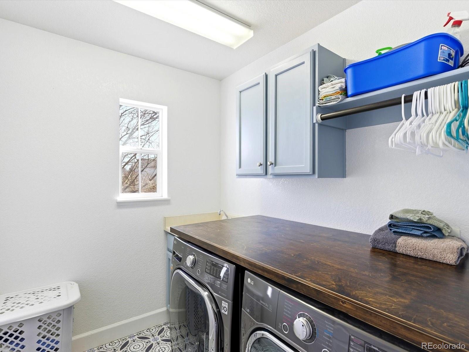 2691 Spruce Street Denver, CO 80238 - Photo 29 of 36 a kitchen with stainless steel appliances a sink dishwasher and a stove with wooden floor