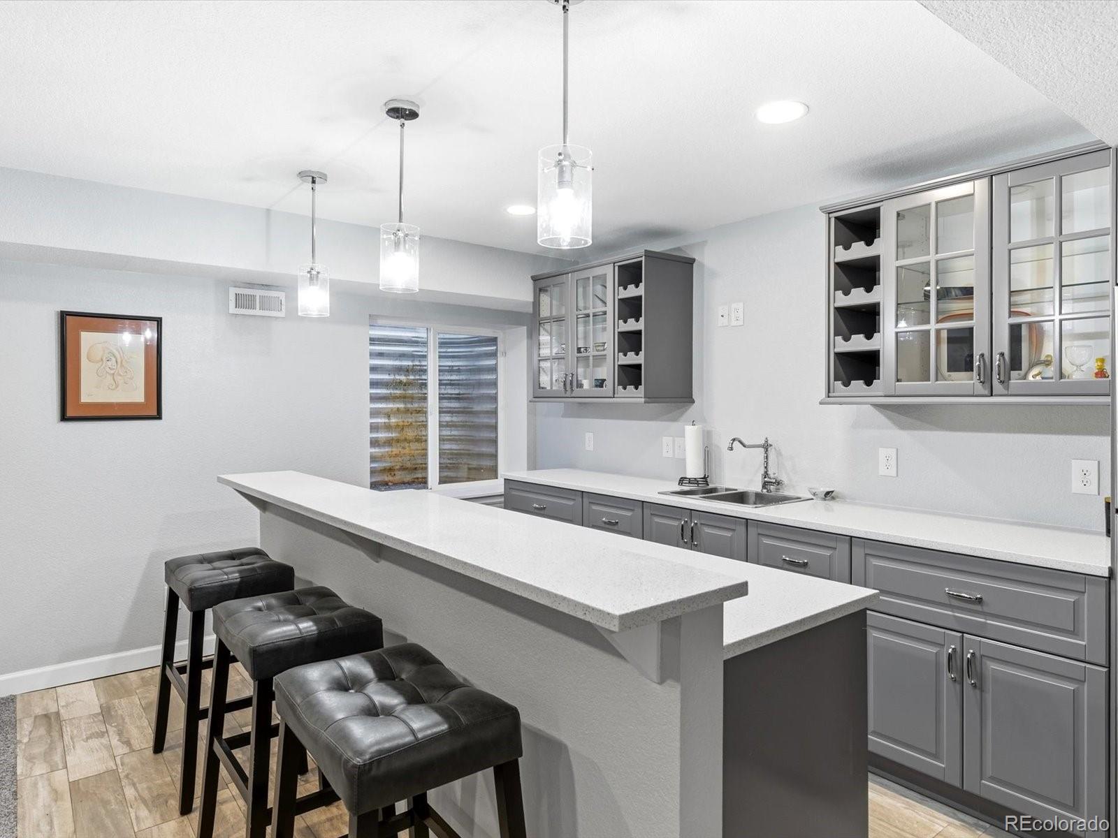 2691 Spruce Street Denver, CO 80238 - Photo 32 of 36 a kitchen with a sink a stove a dining table and chairs