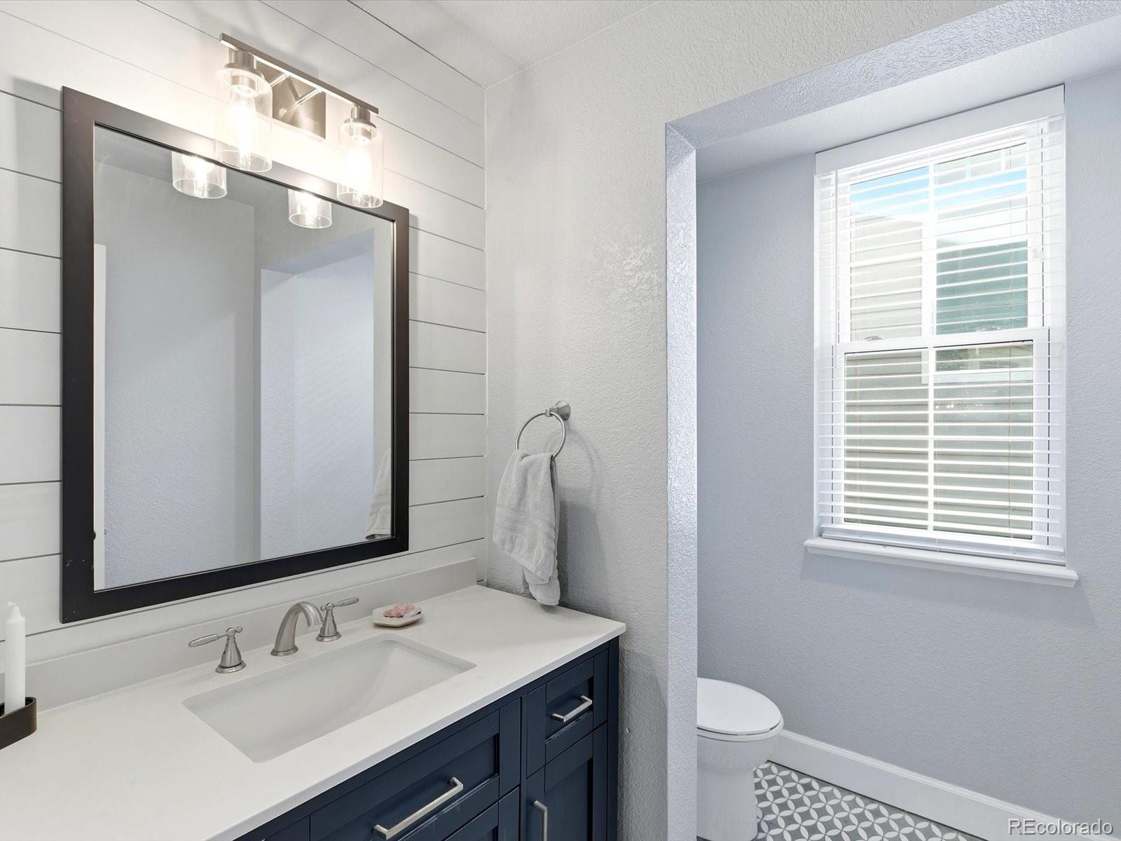2691 Spruce Street Denver, CO 80238 - Photo 8 of 36 a bathroom with a sink a toilet and a mirror