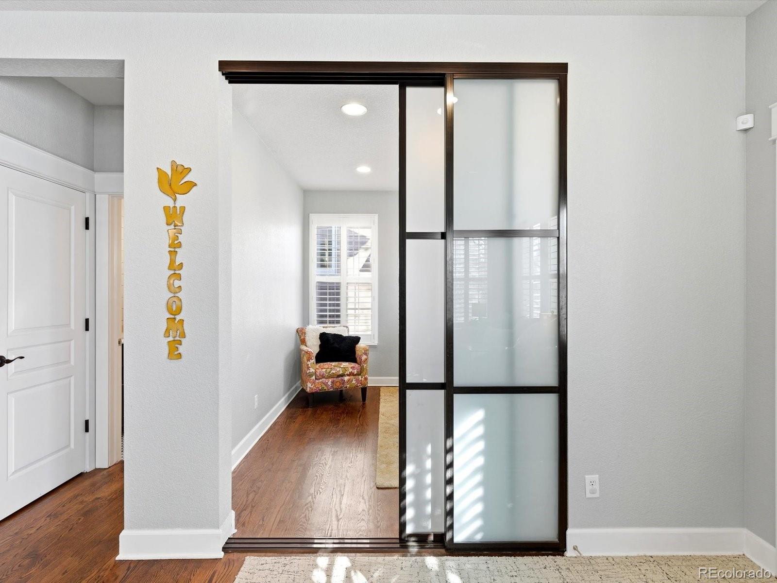2691 Spruce Street Denver, CO 80238 - Photo 10 of 36 a view of a hallway with wooden floor and a living room
