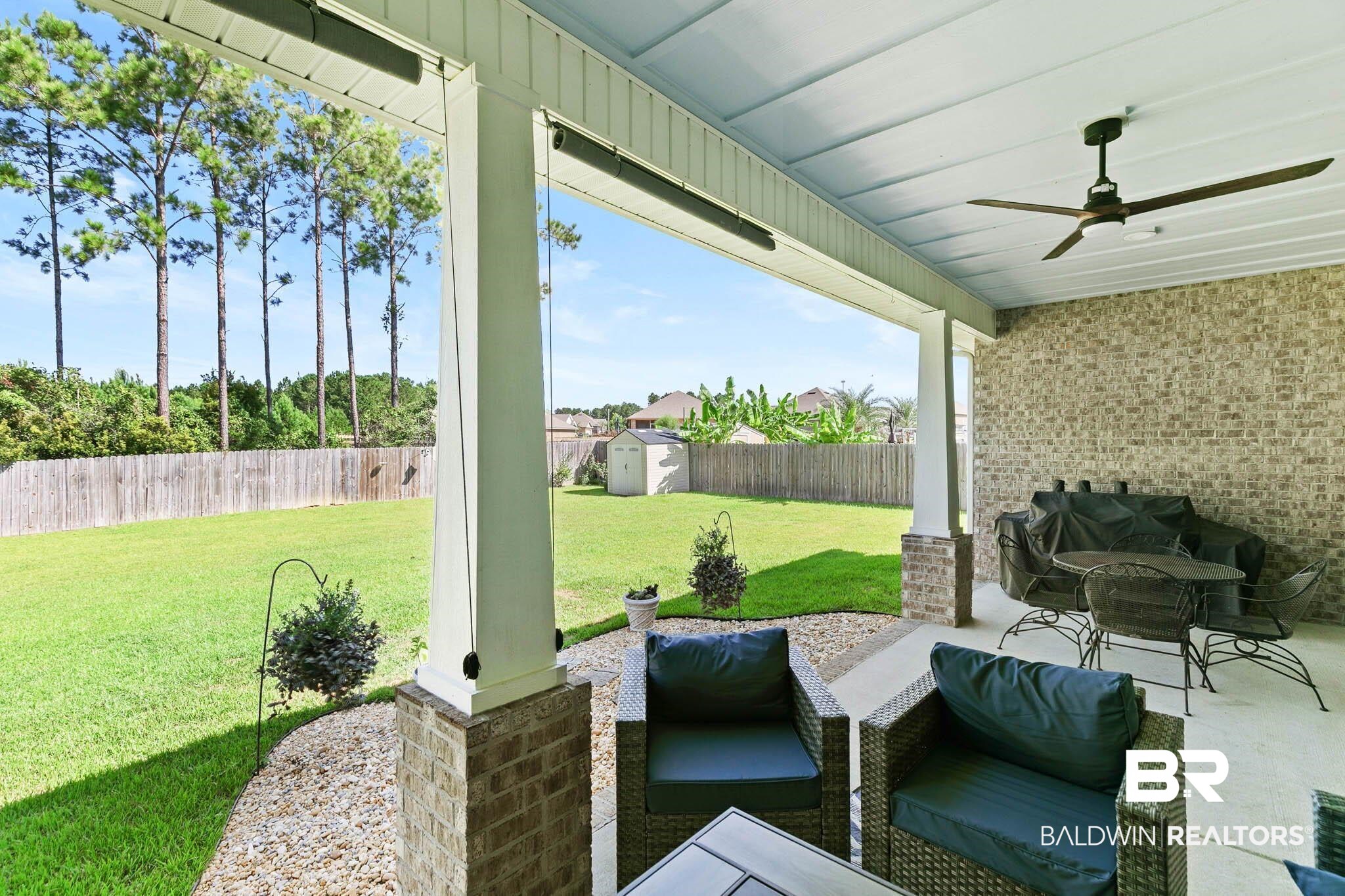 12785 Warbler Street Daphne, AL 36527 - Photo 37 of 53 Fenced backyard with a shed, ceiling fan, and a patio