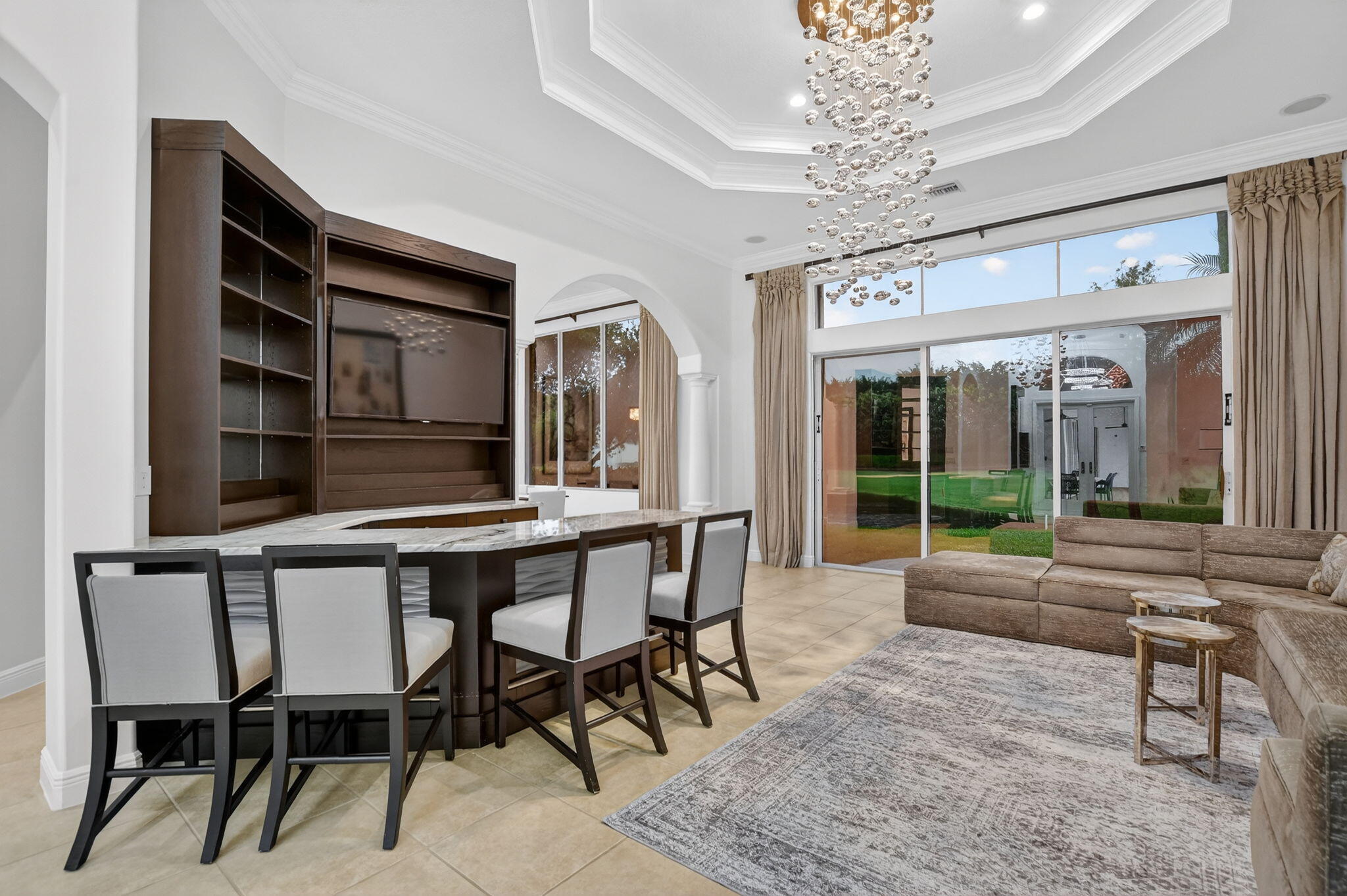 8030 Laurel Ridge Court Delray Beach, FL 33446 - Photo 11 of 87 a living room with furniture a chandelier and a large window