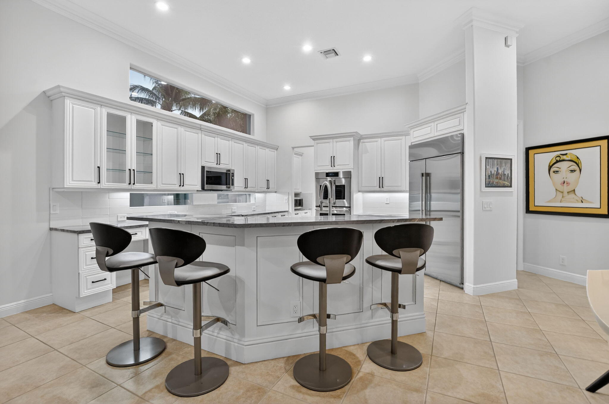 8030 Laurel Ridge Court Delray Beach, FL 33446 - Photo 19 of 87 a kitchen with stainless steel appliances kitchen island granite countertop a sink and cabinets