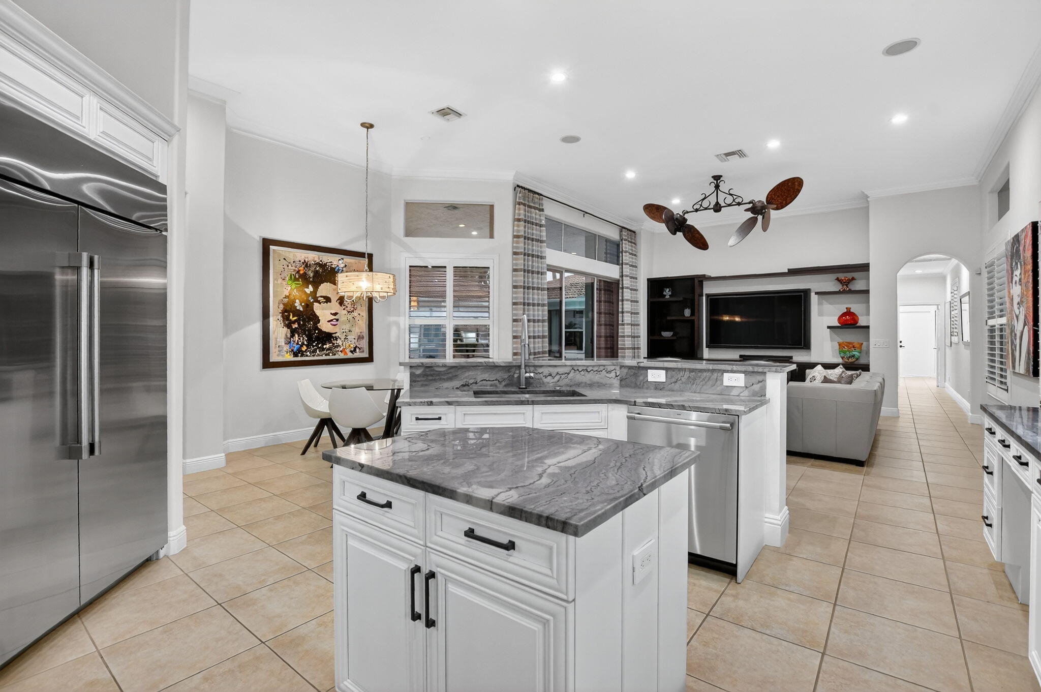 8030 Laurel Ridge Court Delray Beach, FL 33446 - Photo 21 of 87 a kitchen with stainless steel appliances granite countertop a sink a stove and a refrigerator