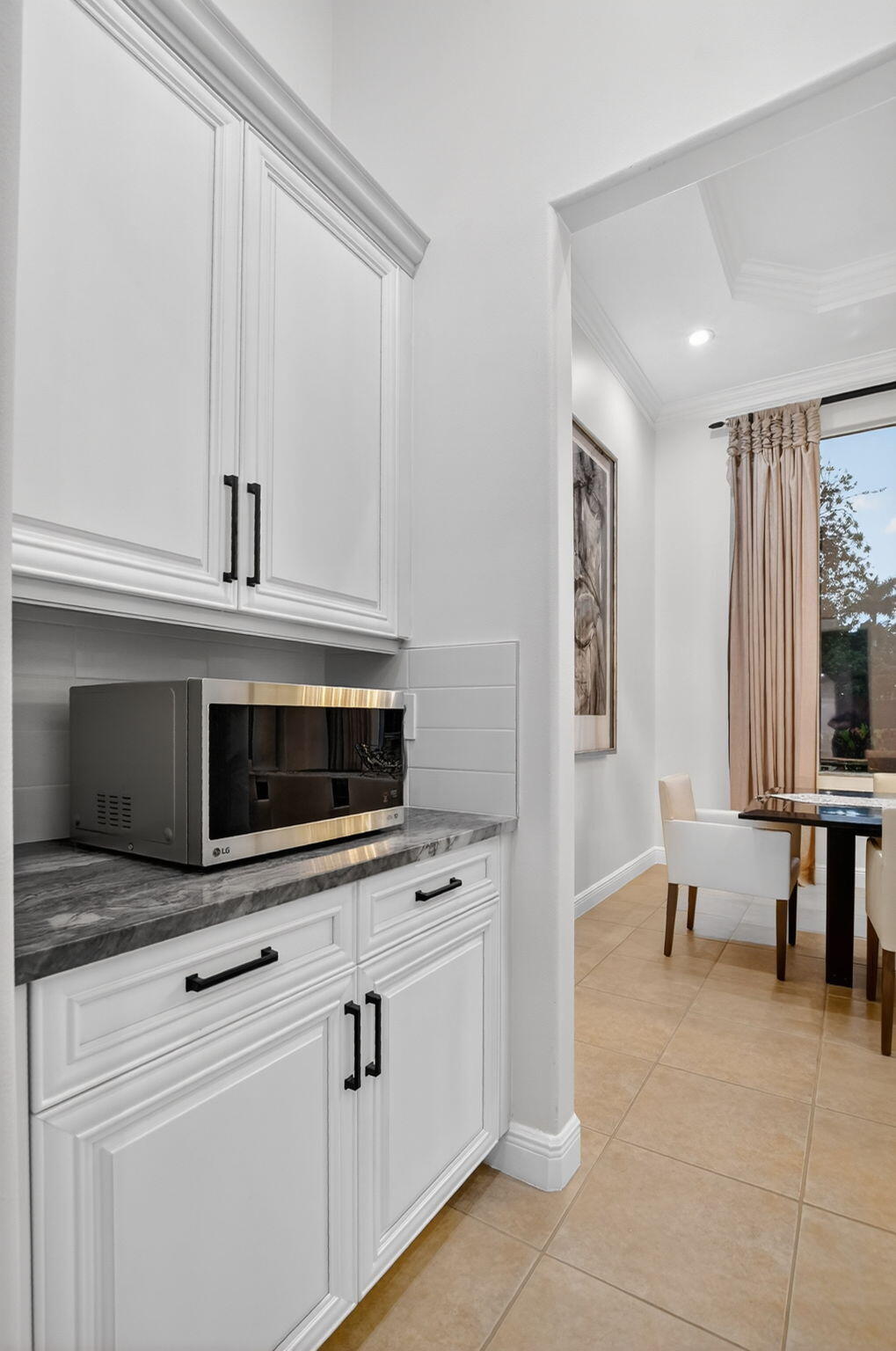 8030 Laurel Ridge Court Delray Beach, FL 33446 - Photo 25 of 87 a kitchen with stainless steel appliances a stove microwave and cabinets