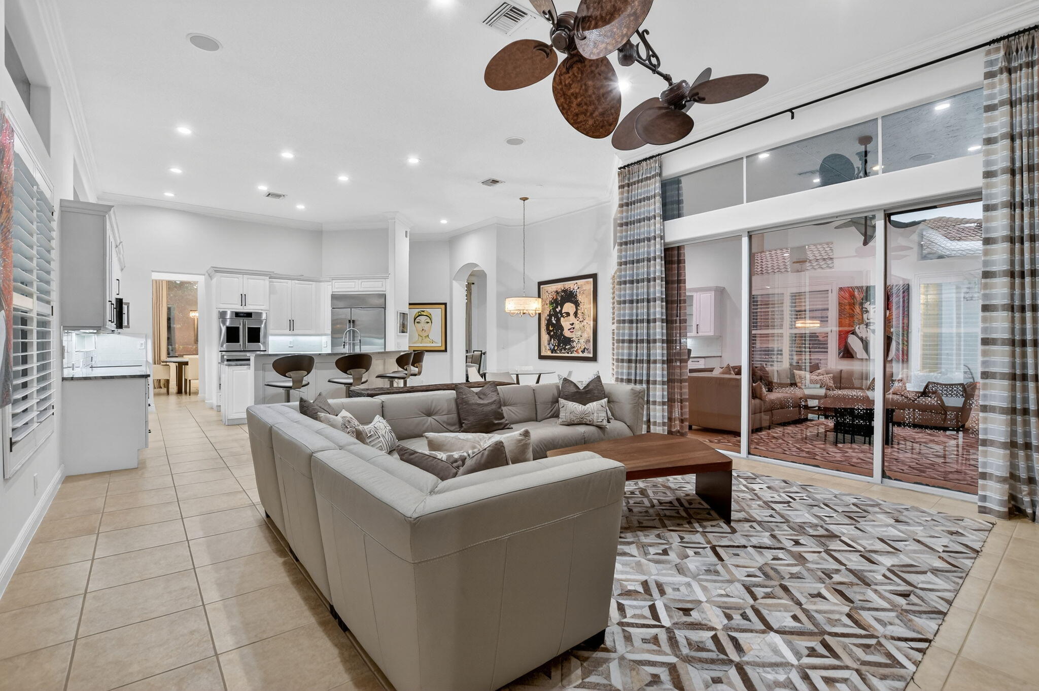 8030 Laurel Ridge Court Delray Beach, FL 33446 - Photo 34 of 87 a living room with furniture and a chandelier