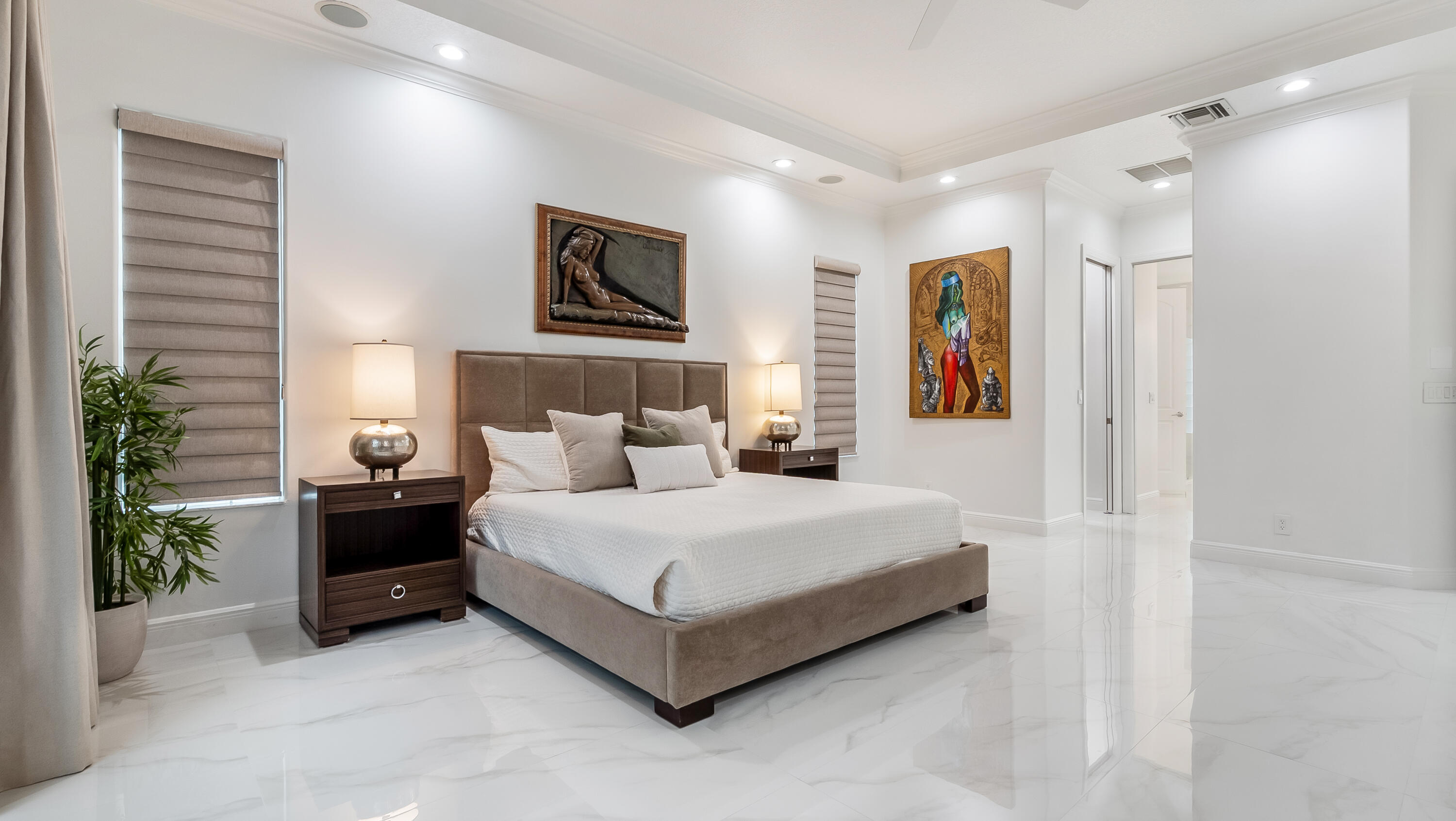 8030 Laurel Ridge Court Delray Beach, FL 33446 - Photo 38 of 87 a spacious bedroom with a bed and a potted plant