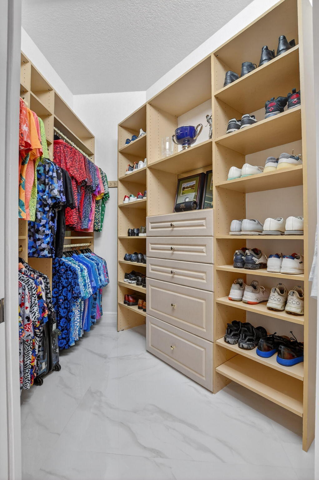 8030 Laurel Ridge Court Delray Beach, FL 33446 - Photo 48 of 87 a view of walk in closet with clothes and shoes