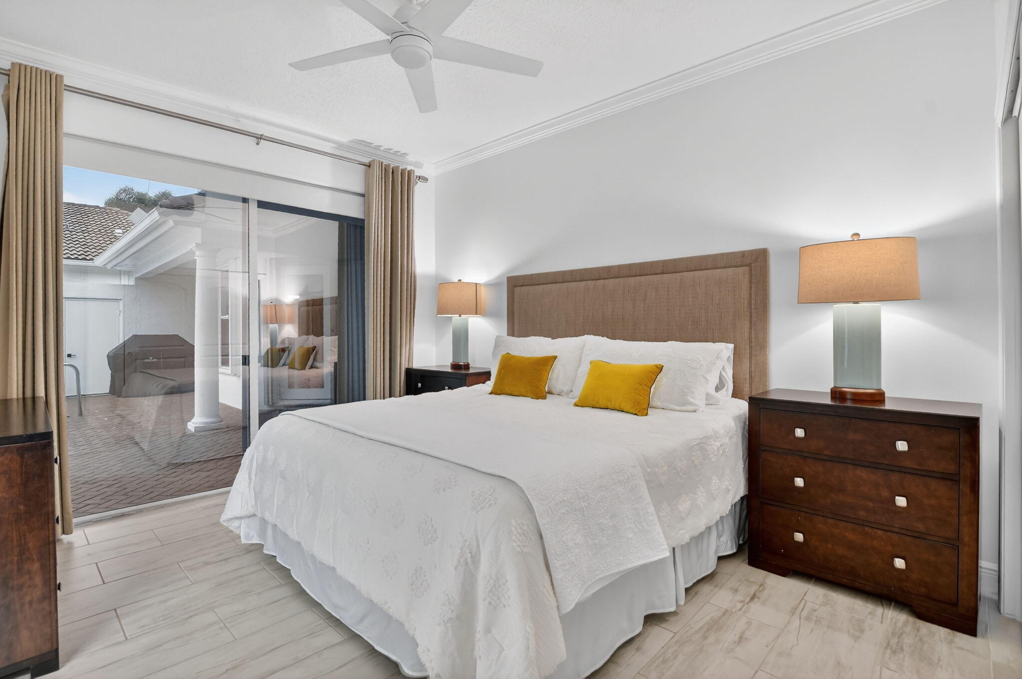 8030 Laurel Ridge Court Delray Beach, FL 33446 - Photo 56 of 87 a bedroom with a bed and a lamp