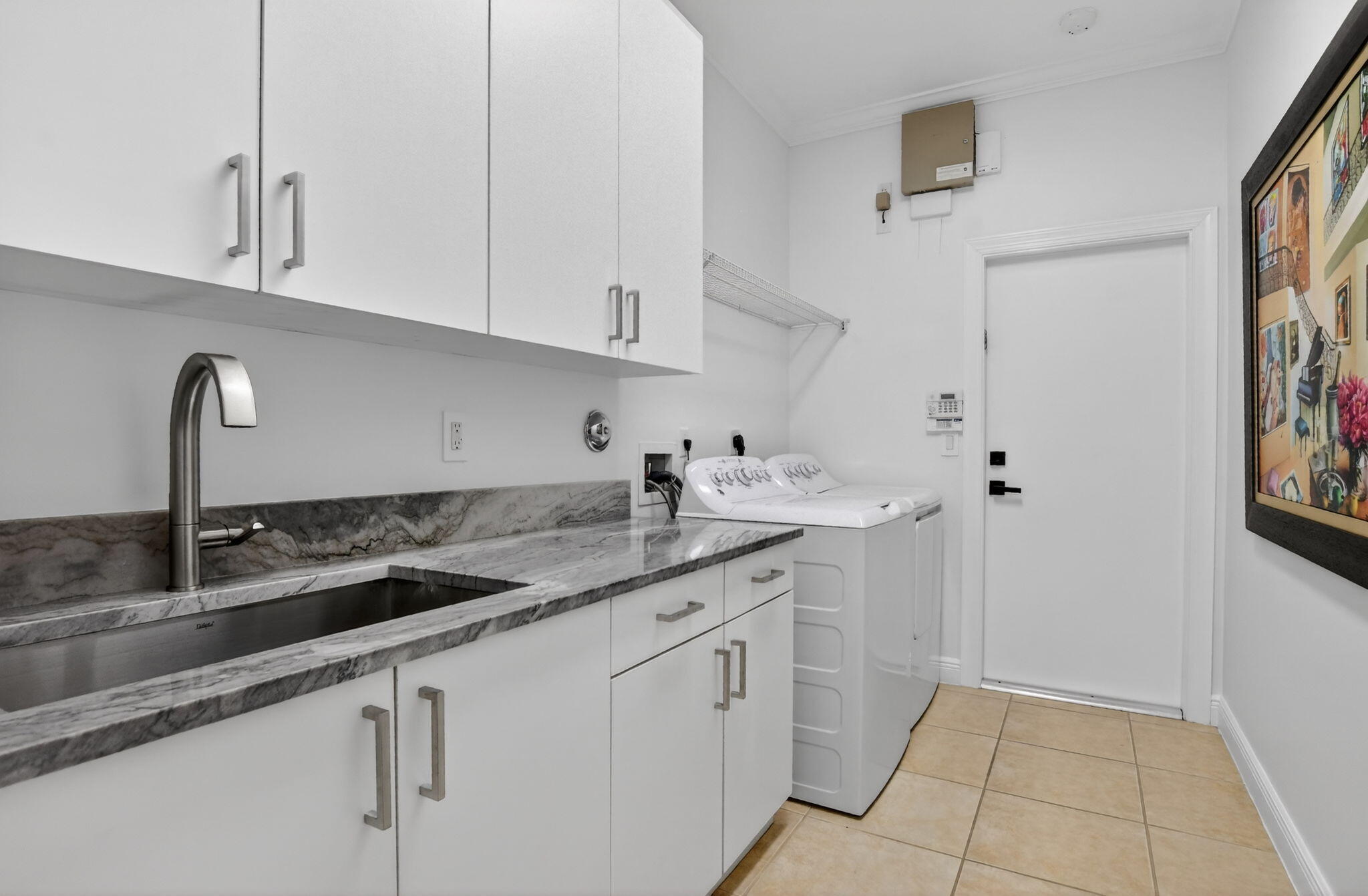 8030 Laurel Ridge Court Delray Beach, FL 33446 - Photo 63 of 87 a kitchen with granite countertop white cabinets and a sink