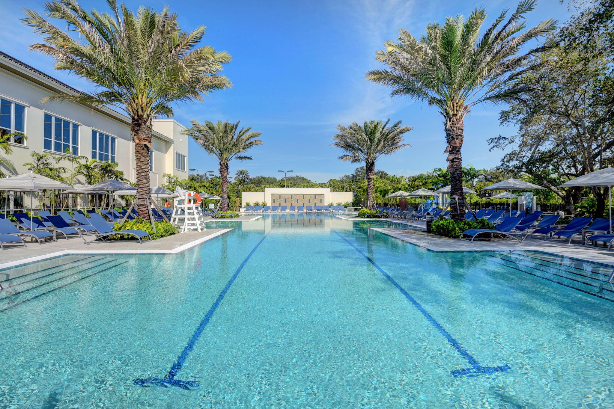 8030 Laurel Ridge Court Delray Beach, FL 33446 - Photo 79 of 87 a view of a swimming pool with a table and chairs