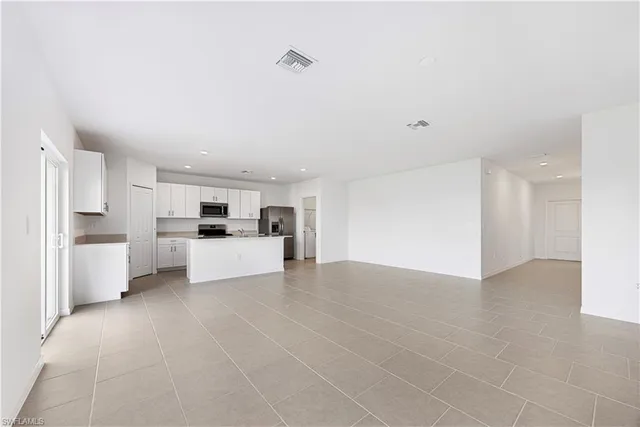 a kitchen with cabinets and stainless steel appliances