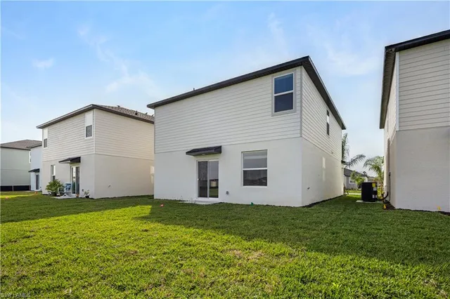 an aerial view of residential houses with outdoor space and swimming pool