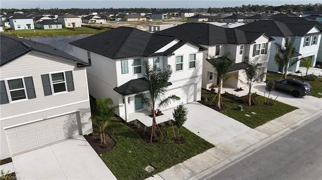 a view of a house with backyard porch and sitting area