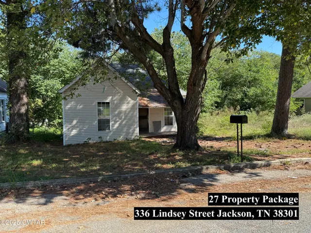 a view of a house with a tree in front