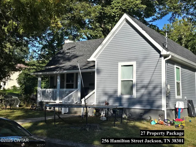 a view of house with backyard and sitting area