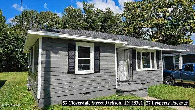 a view of house with backyard