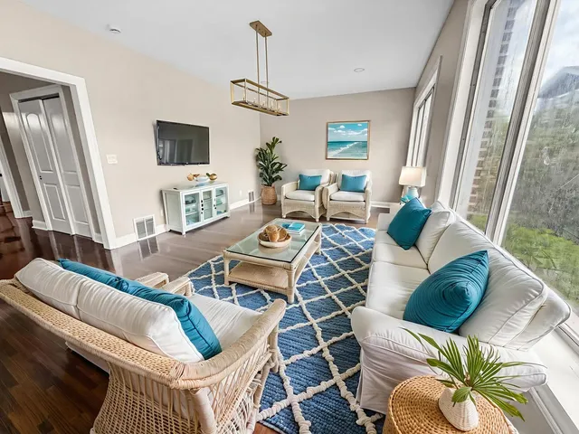 a living room with furniture a couch and a flat screen tv