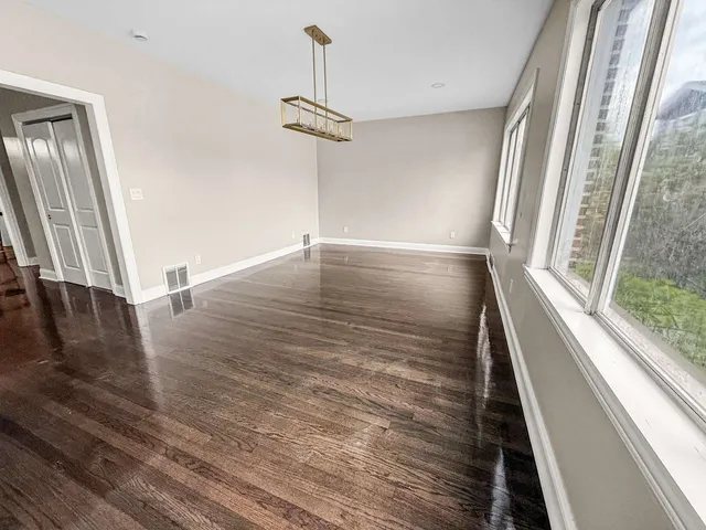 a view of a room with wooden floor