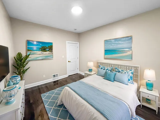 a bedroom with a bed and a potted plant