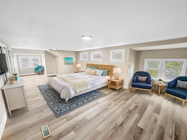 a bedroom with a large bed and a couch