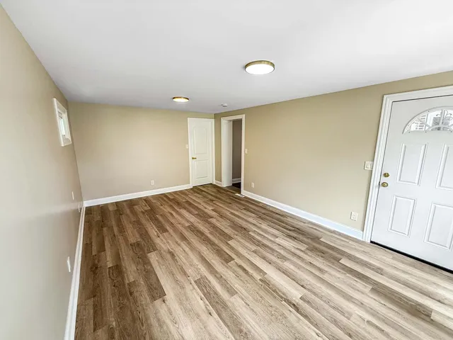 a view of a room with wooden floor and staircase
